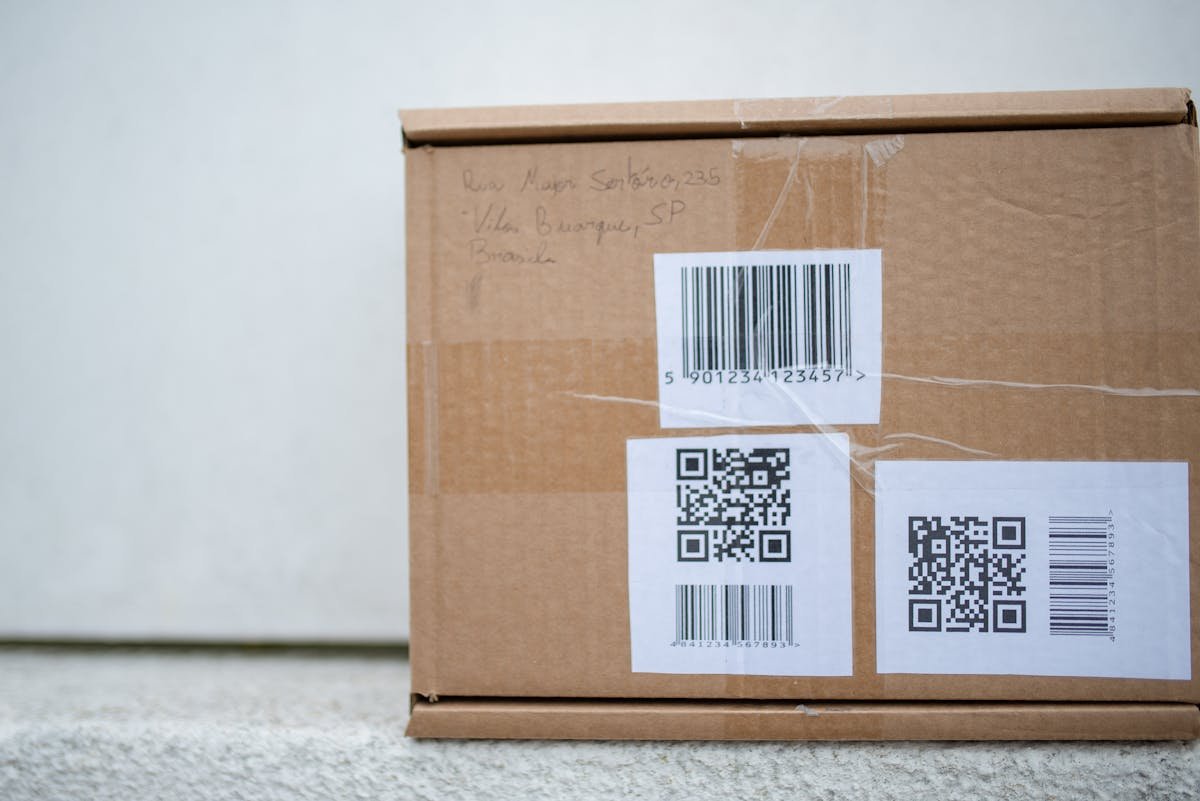 Cardboard package with QR codes and barcode labels