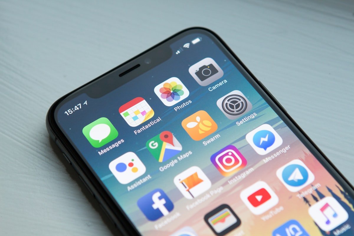 Person holding a smartphone while checking app messages and backup settings