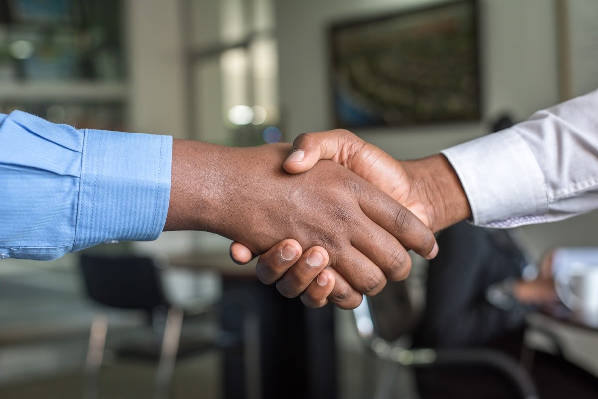 Two people shaking hands during a safe local sale agreement