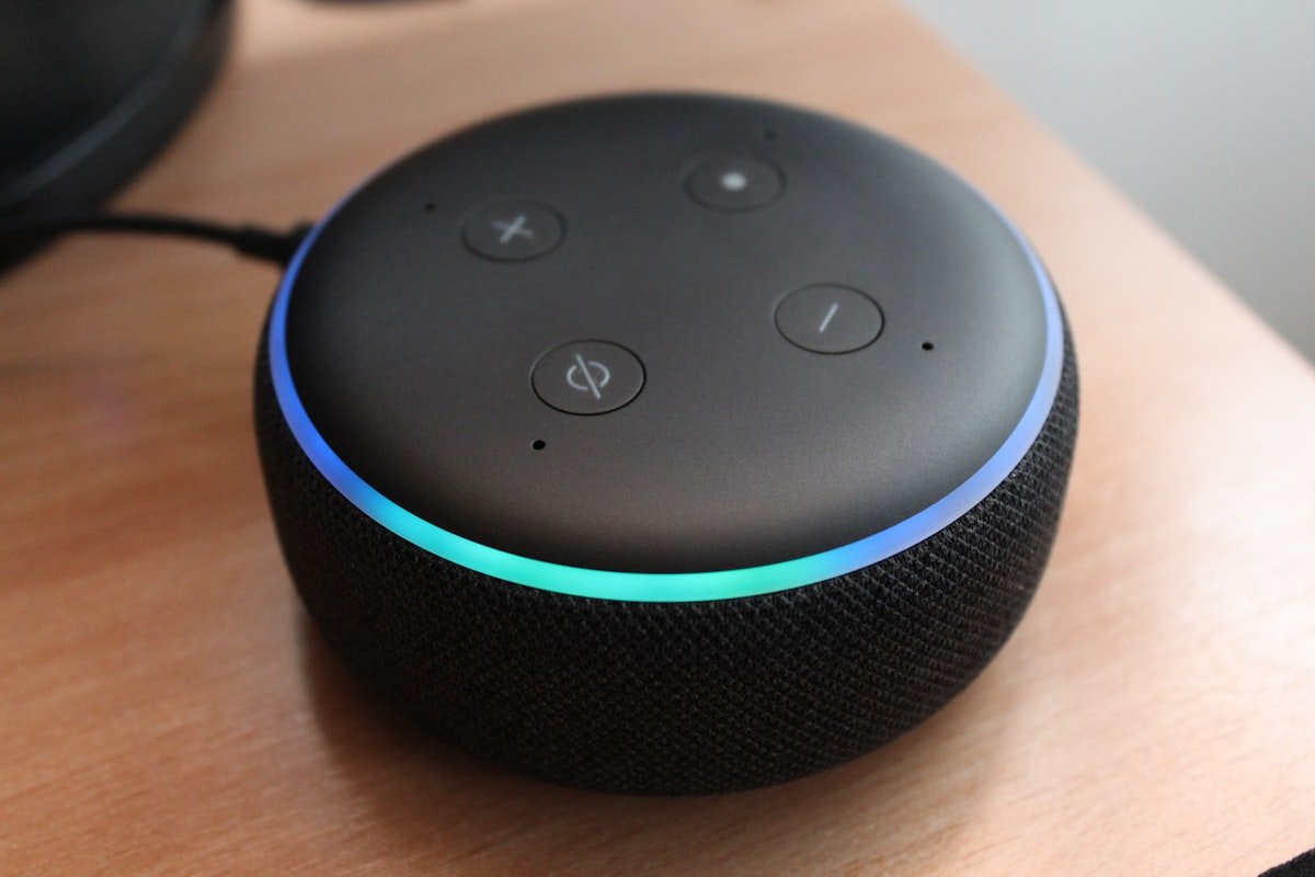 Amazon Echo Dot smart speaker with blue light ring on a table