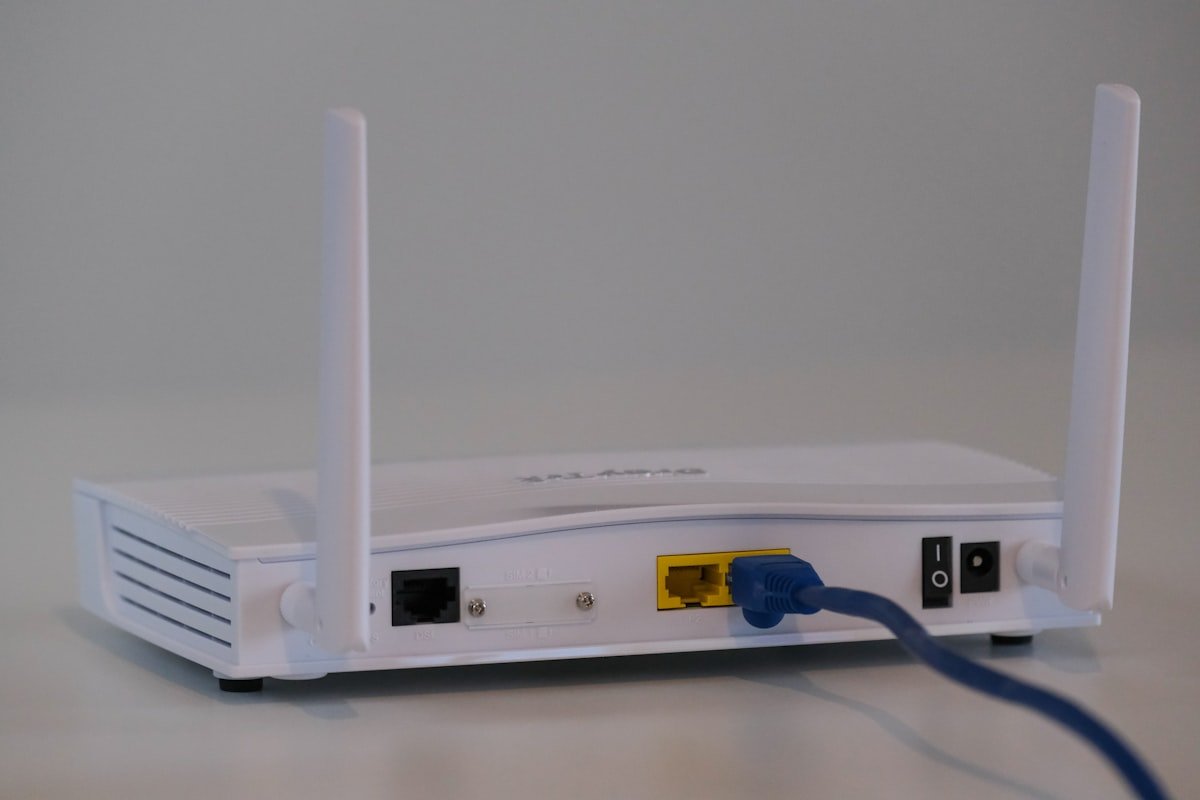 Back of a WiFi router with Ethernet cable plugged in
