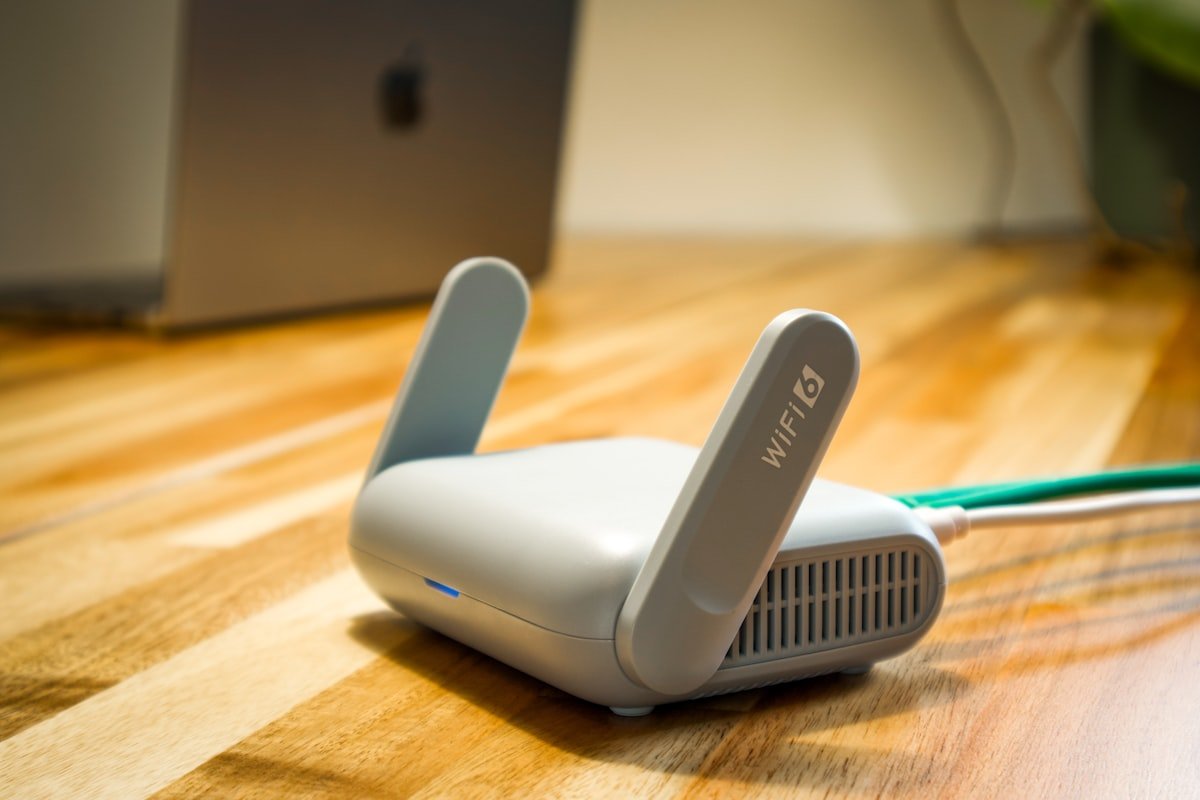 WiFi router on a wooden desk connected with cables